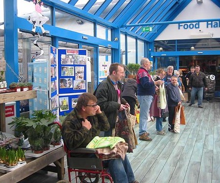 A Morsbags volunteer handing a free fabric bag to a passer-by